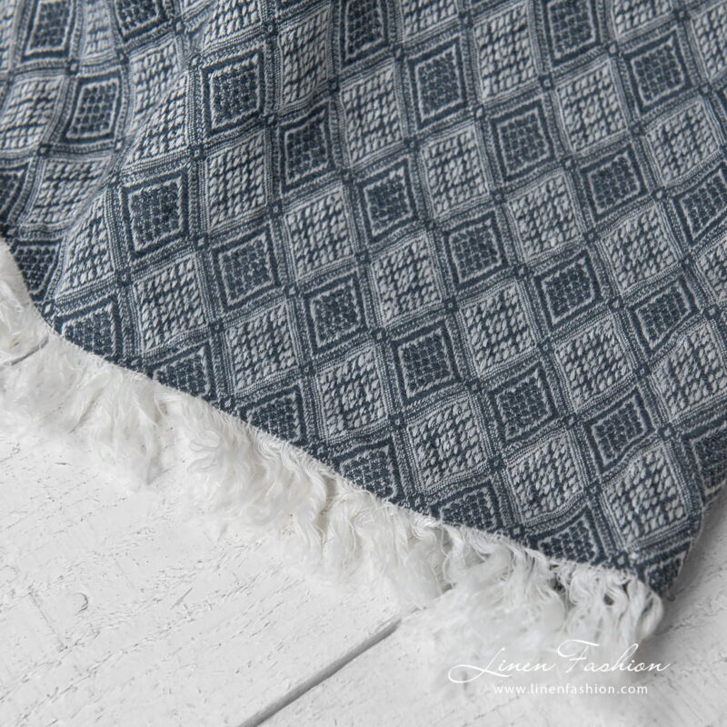 linen blanket with rhombus, with fringes on short sides.