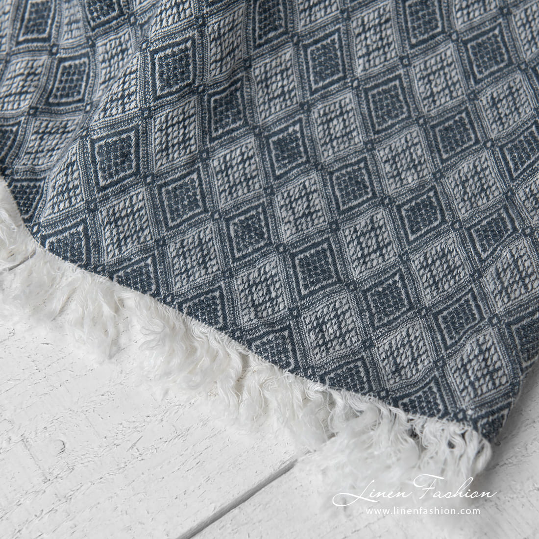 linen blanket with rhombus, with fringes on short sides.