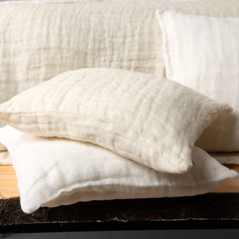 white cream linen bedspread, with decorative cushions