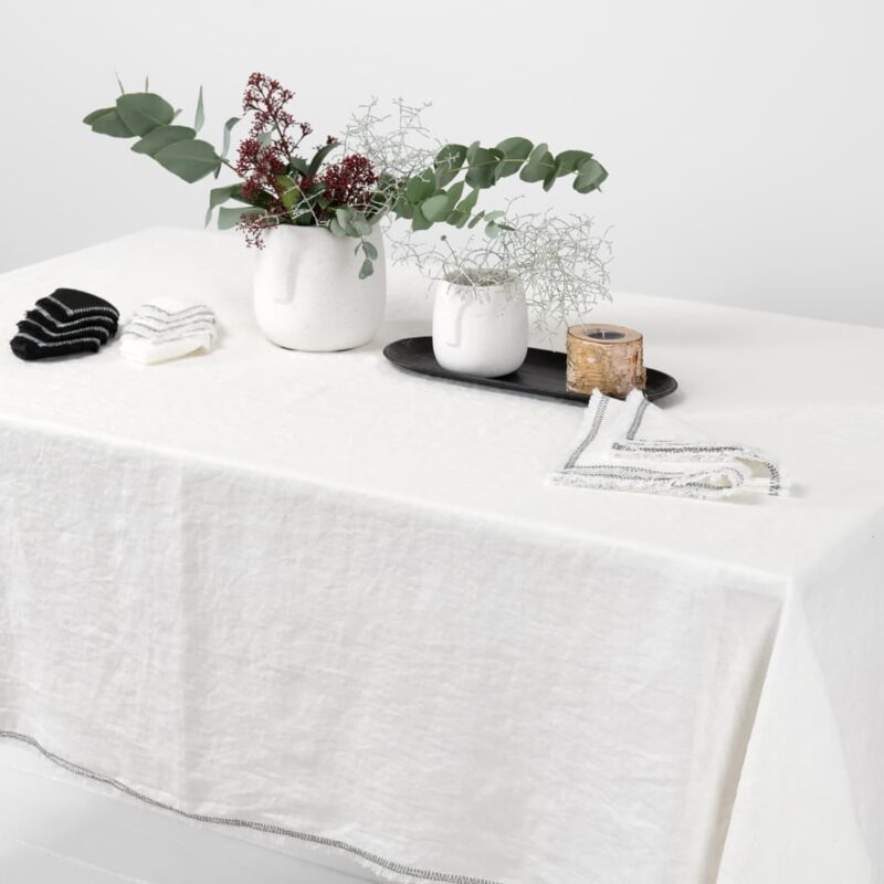 white linen tablecloth with decorative seam, washed.