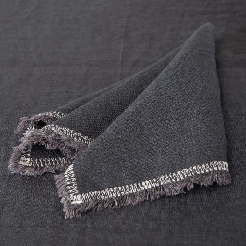 grey linen napkin with decorative stitch, with 1.5cm. loose fringes.
