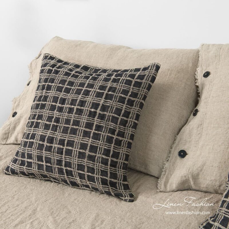 Linen cushion cover in grey color, focus.