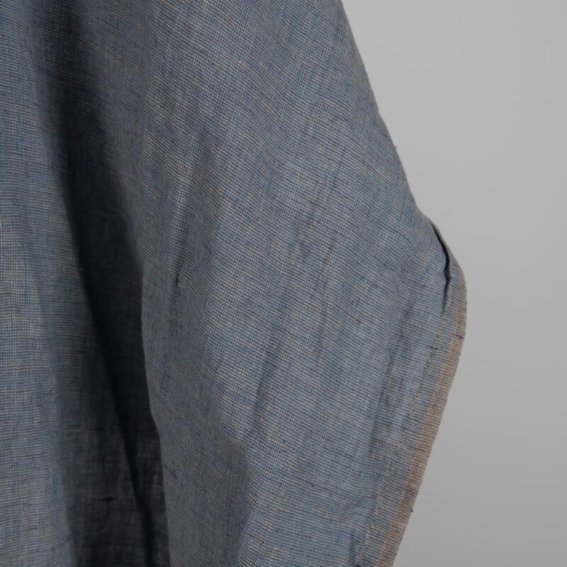 Linen Fabric Brownish Blue Color Washed for sewing clothes and home textiles close up edge view