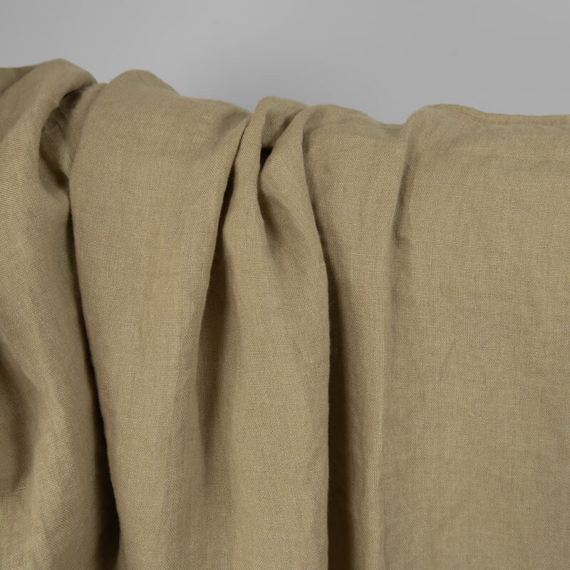 Washed linen fabric in greenish-beige, texture