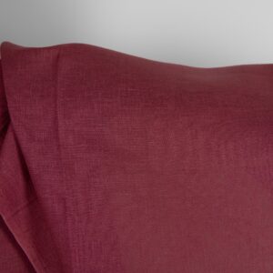 Linen fabric in dark cherry red colour close up detail