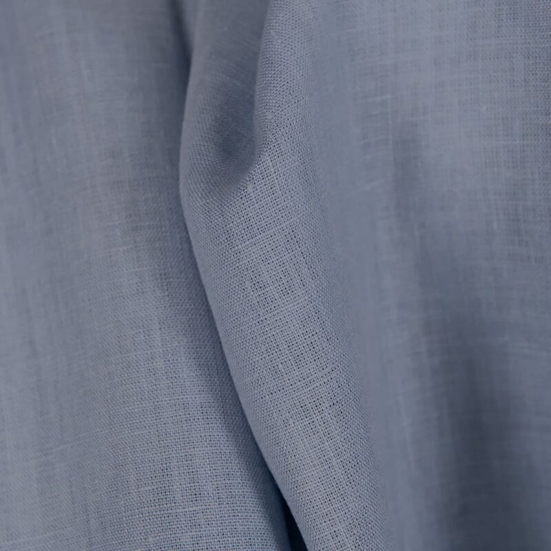 Linen fabric in plain greyish blue colour close up detail