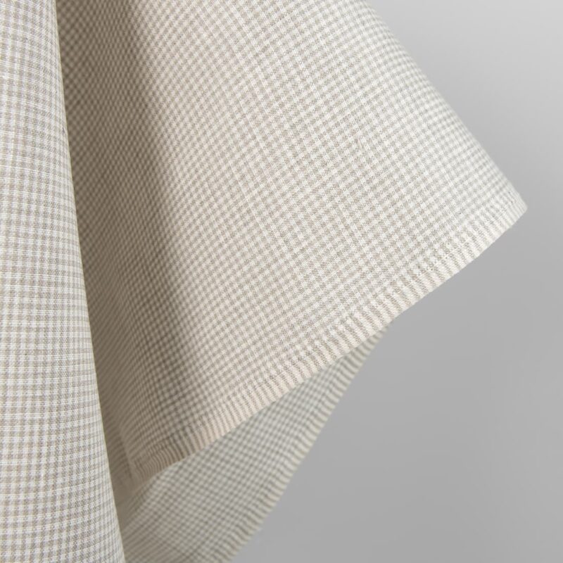 Linen fabric in natural and white colour checks close up edge view