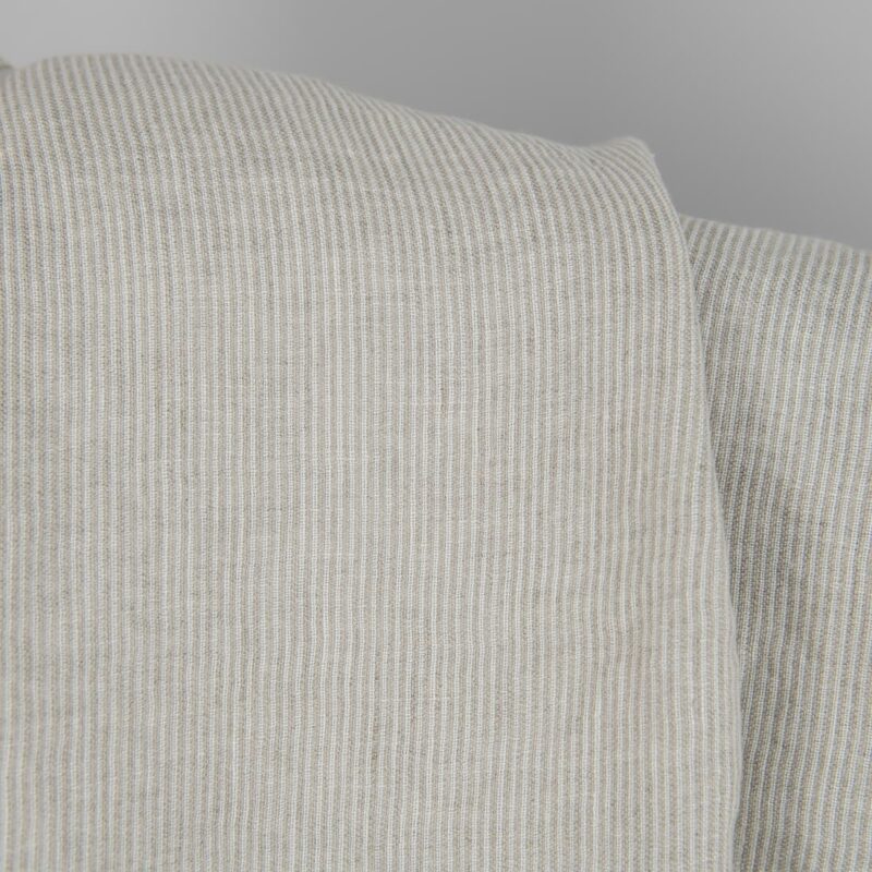 Washed linen fabric in natural and white colour stripes close detail view