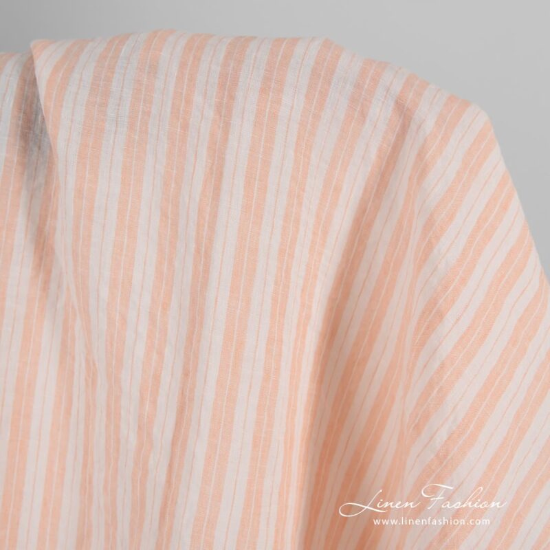 Striped linen fabric in peach color, washed