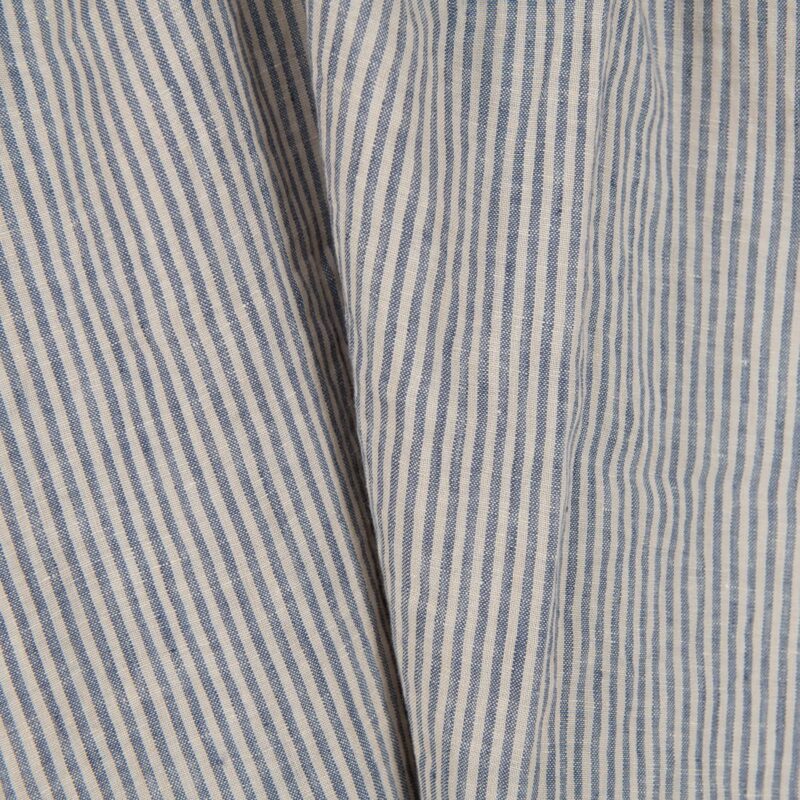 Washed linen fabric with brownish and blueish grey stripes close up view