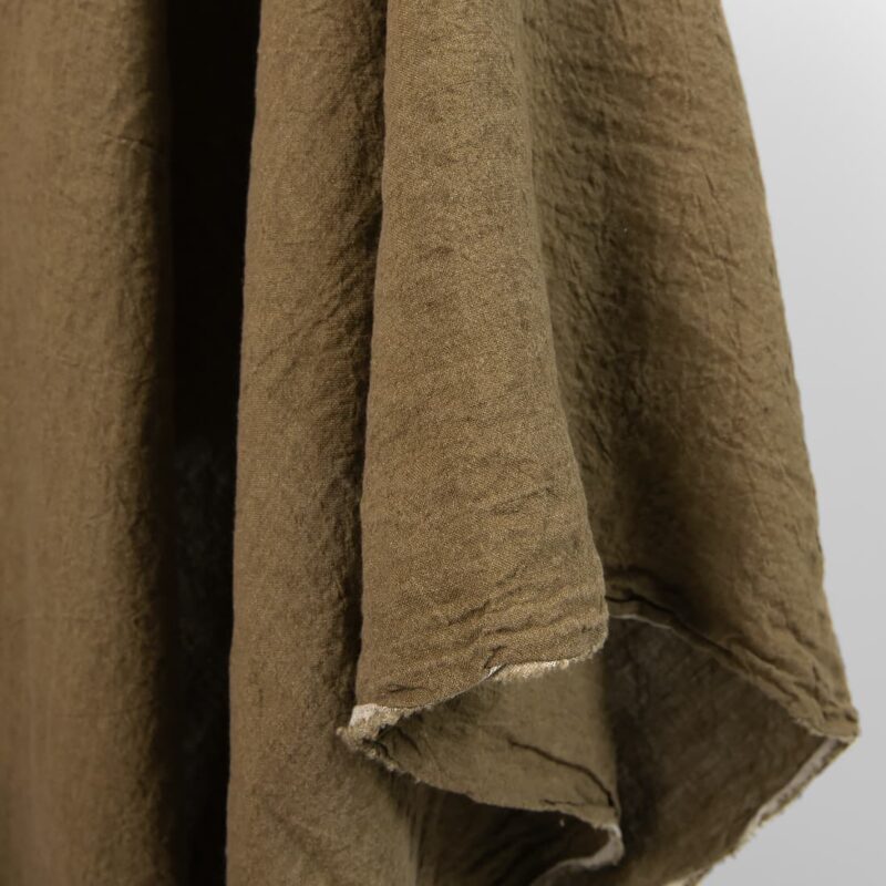 Wide washed linen fabric moss brown colour close view of edge