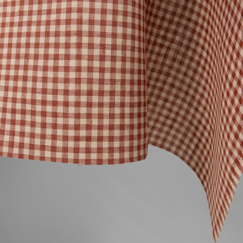 Linen fabric in sand red checks close up edge view