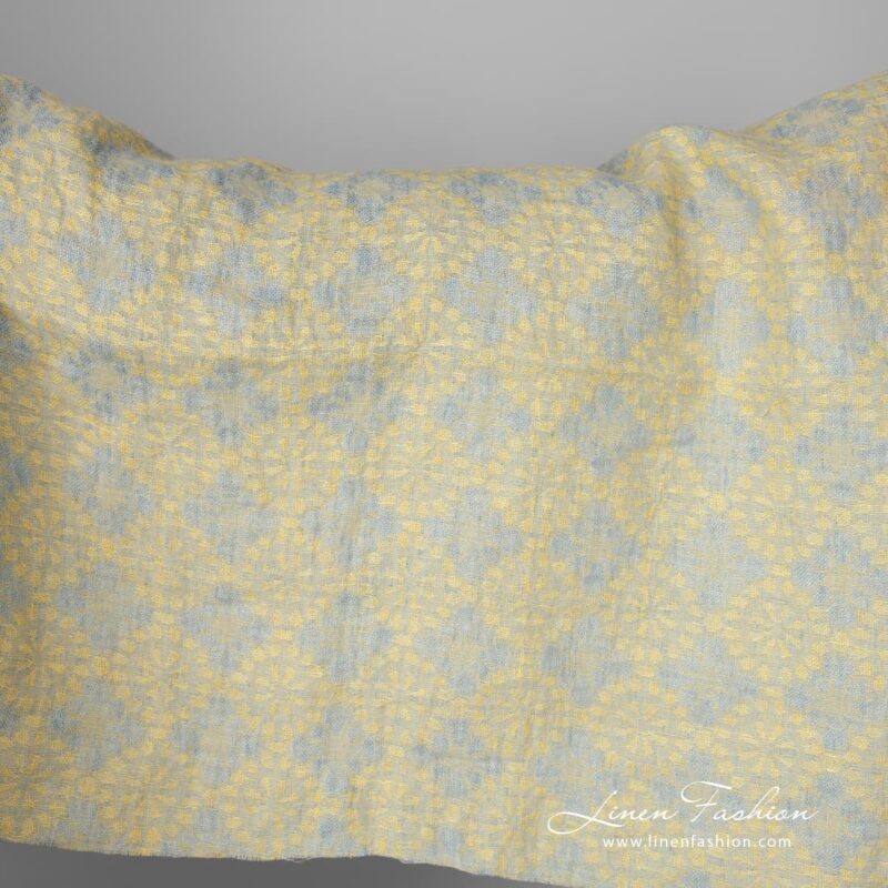 Washed linen fabric in a jacquard flower pattern, made from light bluish grey and light yellow yarns