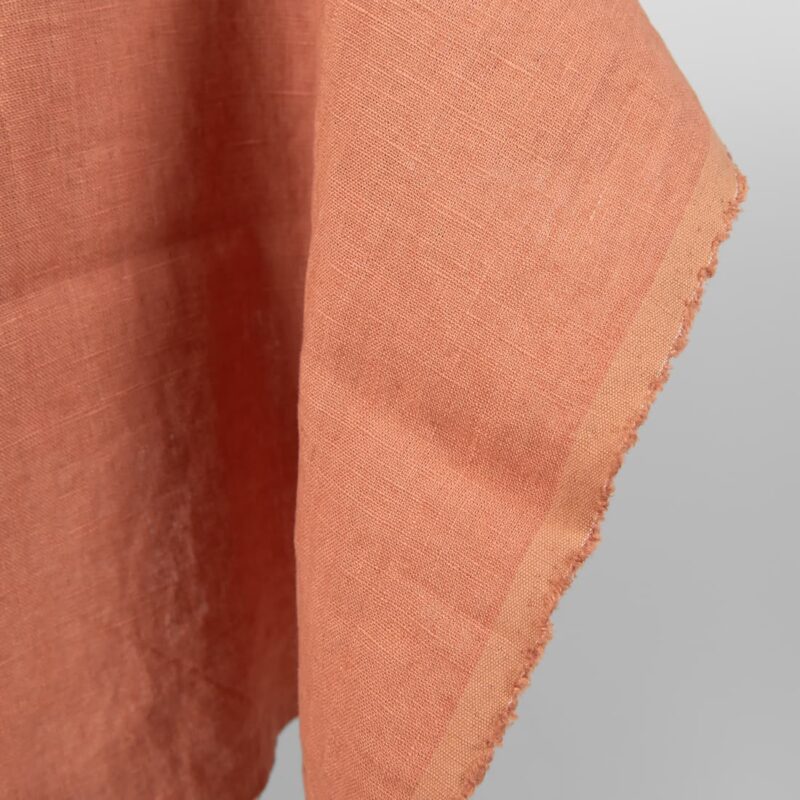 Washed linen fabric coral nude colour close edge view