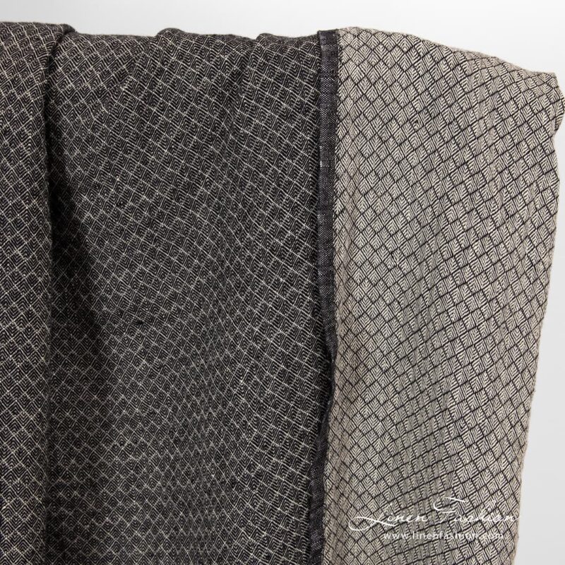 Linen fabric in small black grey diamond pattern.