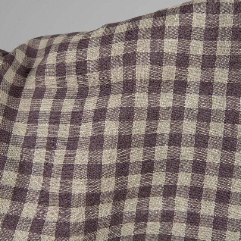 Linen fabric in natural and purple colour checks close up detail