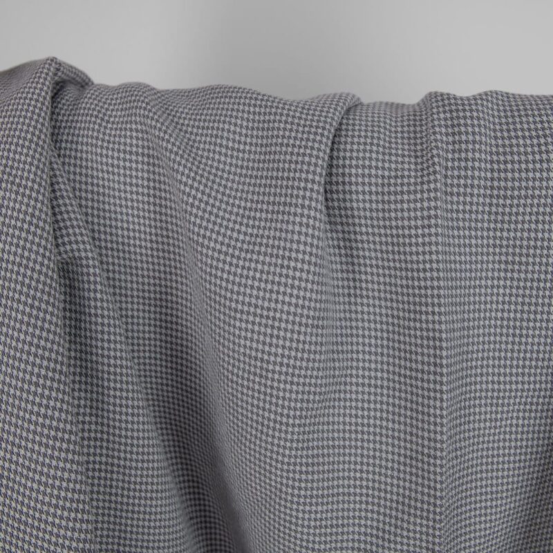Washed linen cotton fabric grey houndstooth pattern close up detail