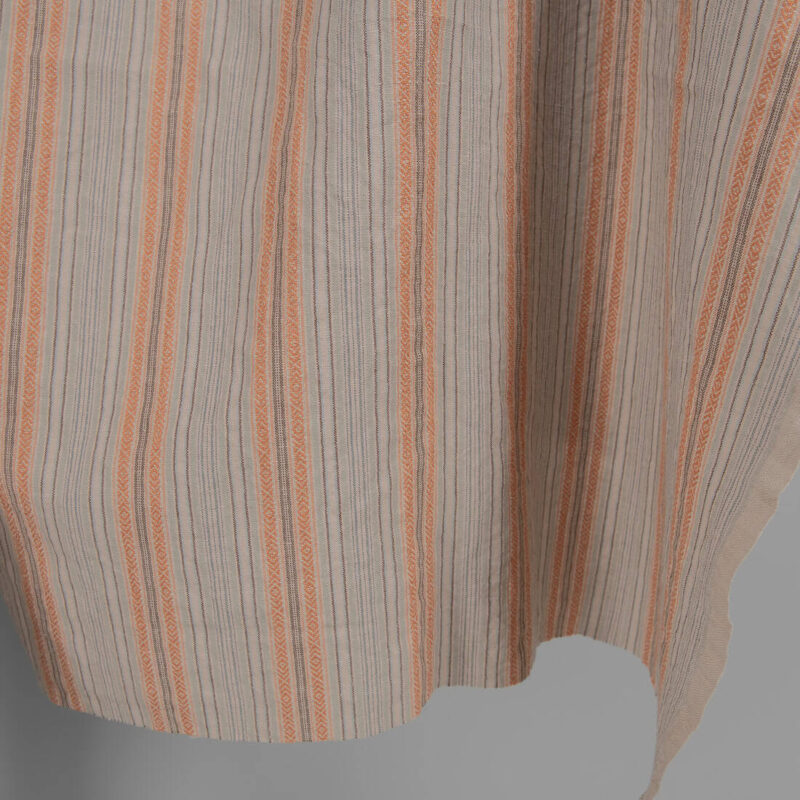 Washed linen cotton in brown patterned stripes edge view