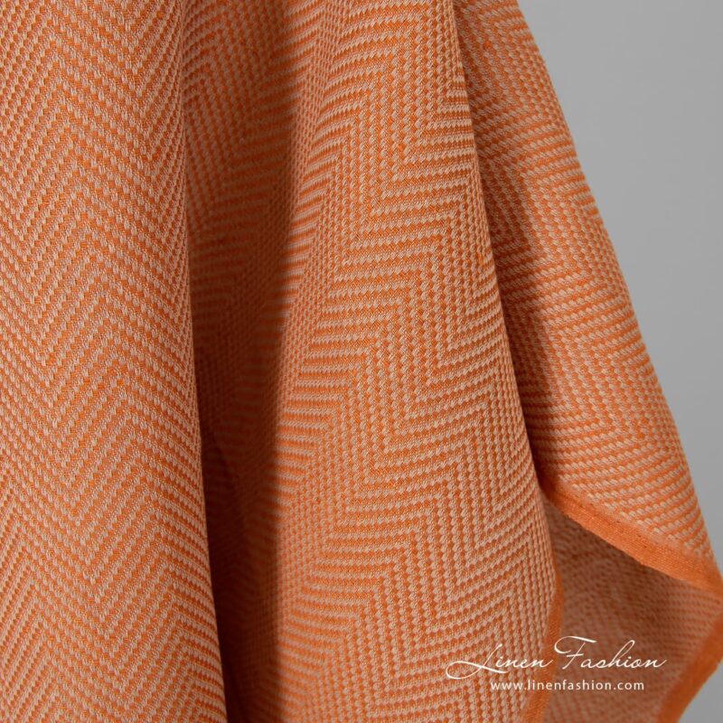Orange dyed linen cotton fabric, herringbone.