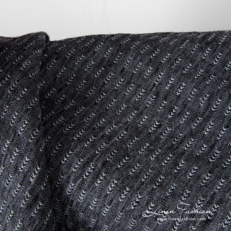Closer view of black and grey tick pattern linen fabric, washed