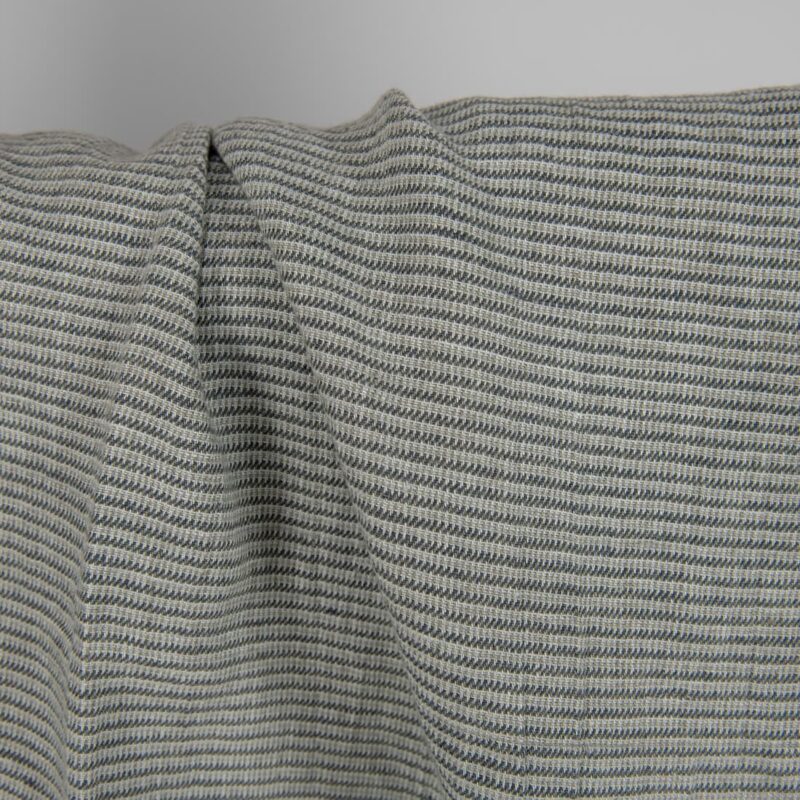 Washed linen fabric green-grey small pattern close up detail