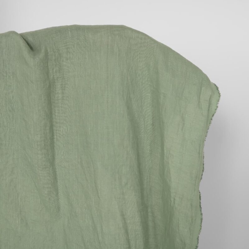 Washed linen fabric in muted light green, 100% linen