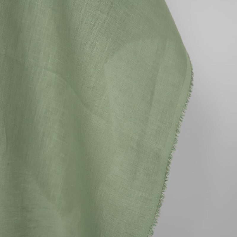 Linen fabric in muted light green, fabric edge