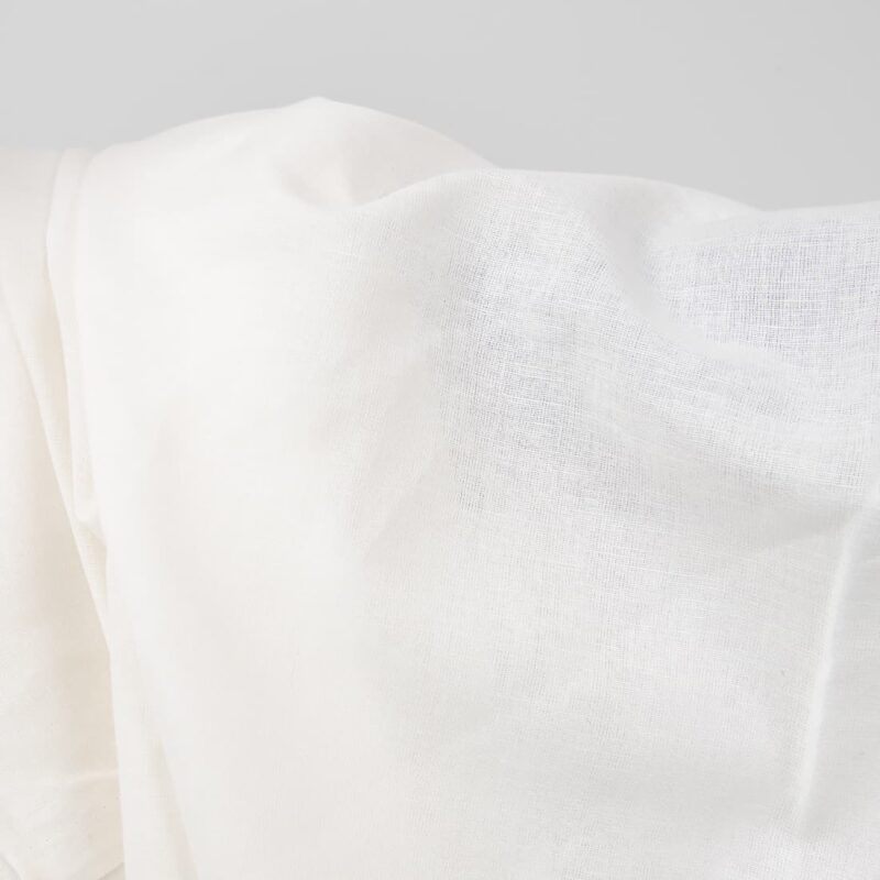 Wide linen cotton fabric white colour close up photo