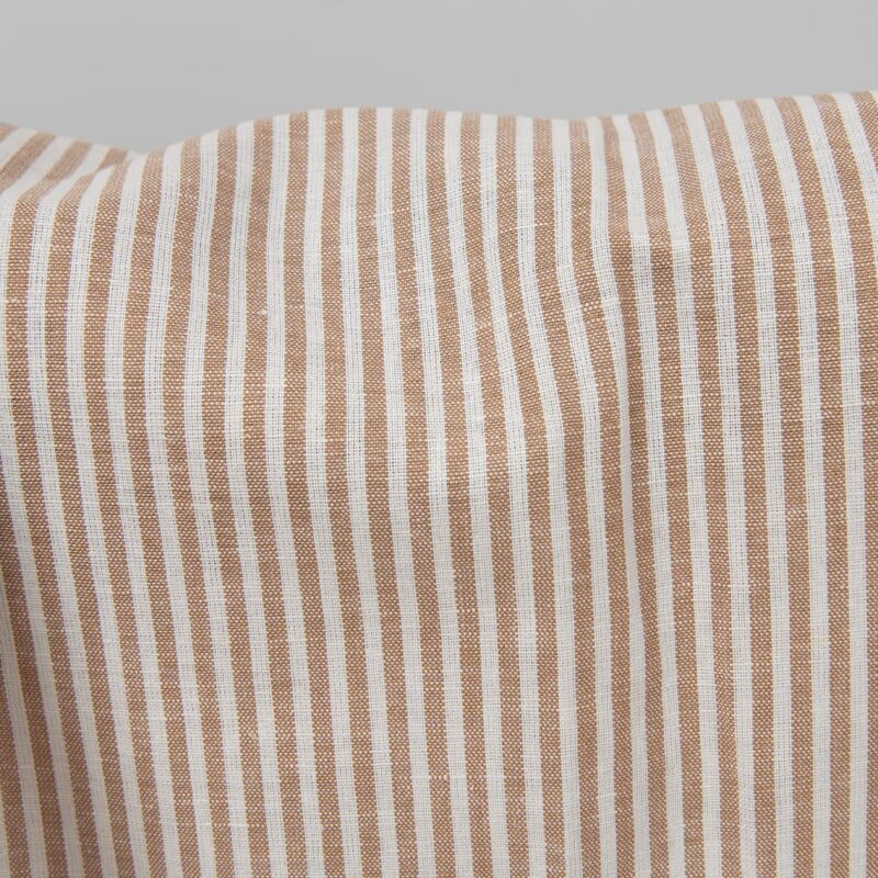 Wide linen cotton fabric in white and brown stripes close up detail