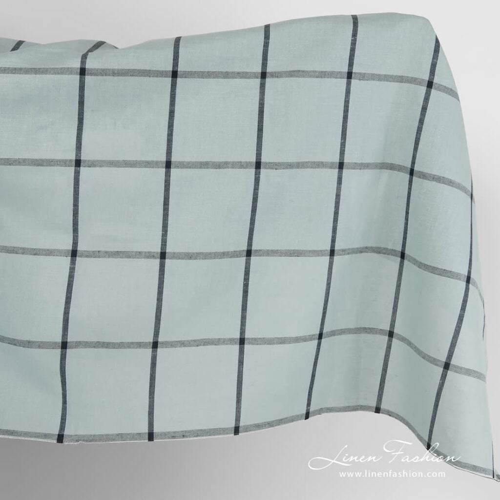 Pale blue linen cotton fabric with black grids.