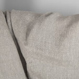 Openwork patterned linen fabric in beige close up detail