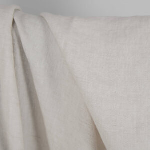 Washed linen wool fabric beige in herringbone pattern close up detail