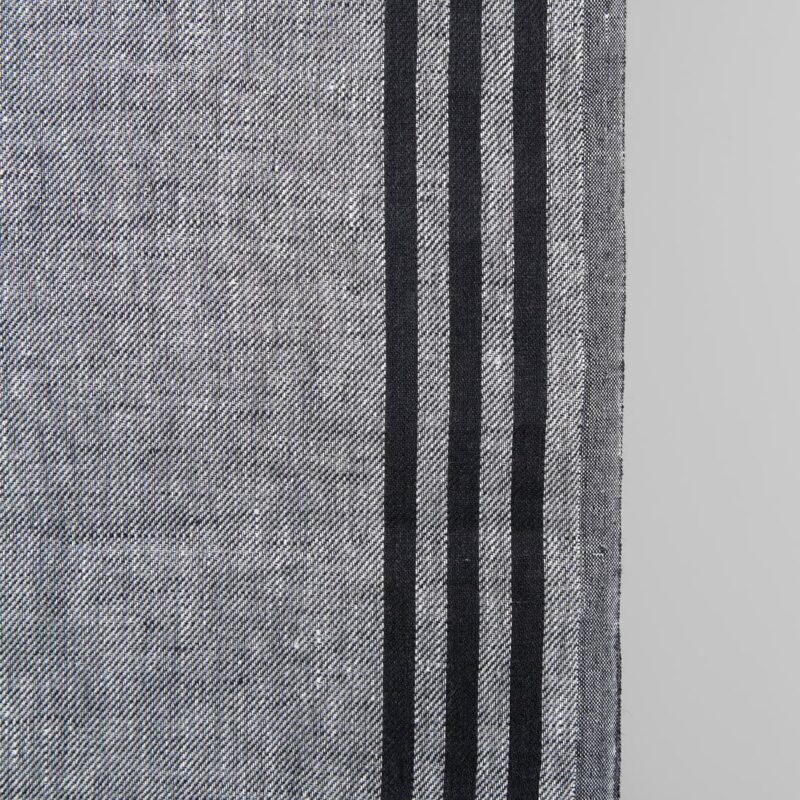 Narrow linen fabric grey with black stripes on sides close up detail