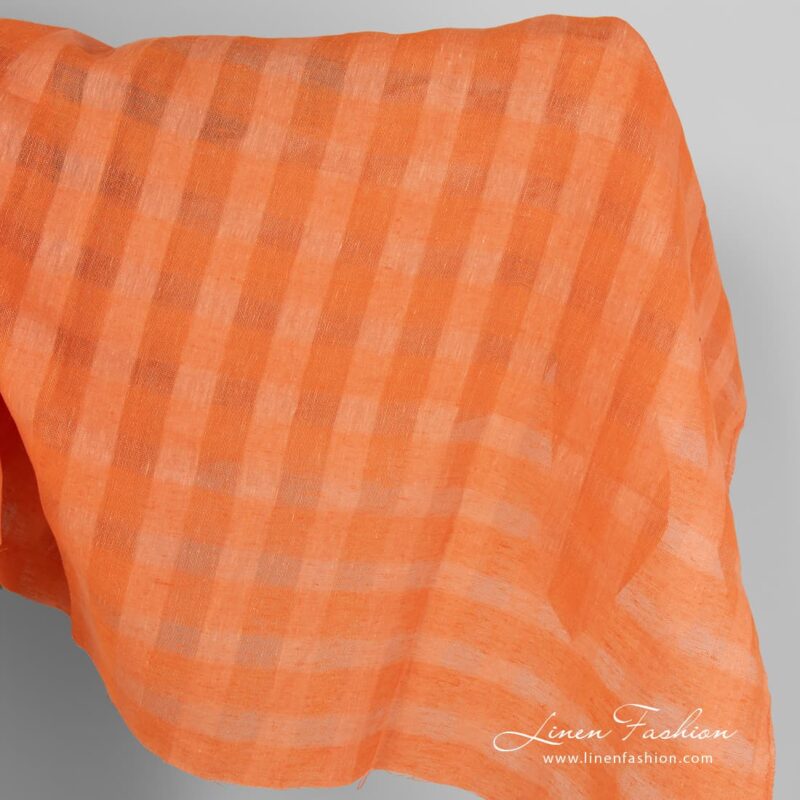 Linen fabric in peachy orange sheer checks.