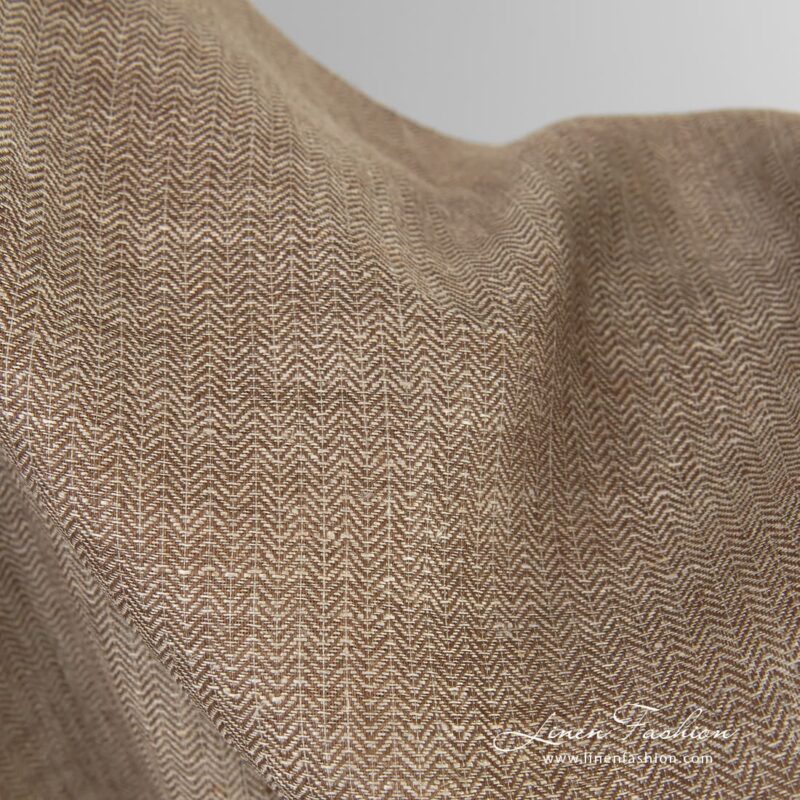 Greyish brown linen fabric in herringbone pattern