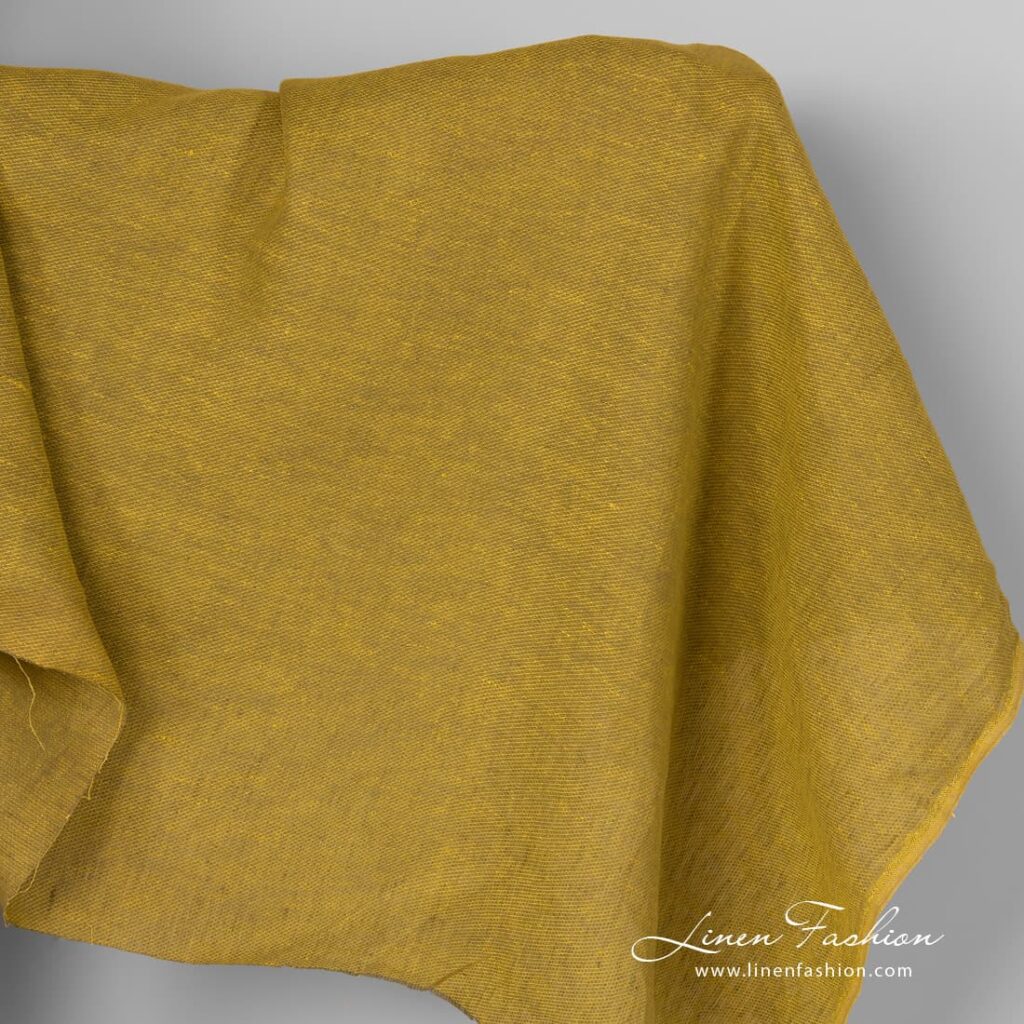 Yellow green linen fabric in diagonal pattern.