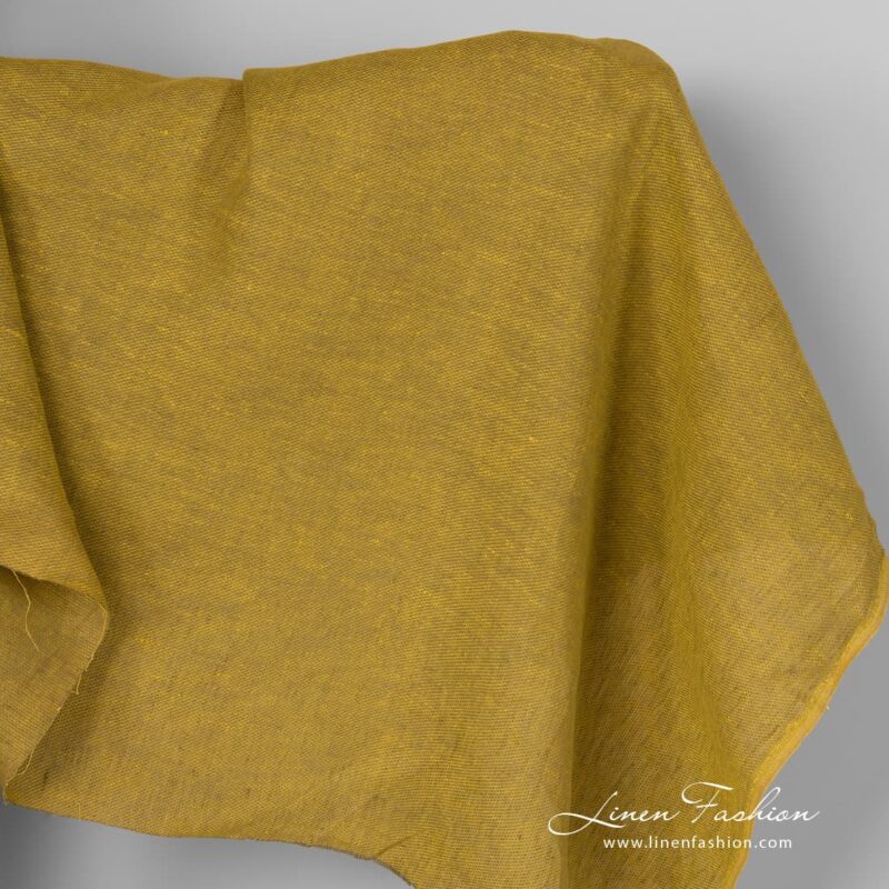 Yellow green linen fabric in diagonal pattern.