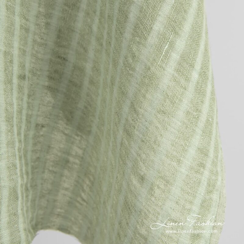 Green linen fabric in transparent vertical stripes