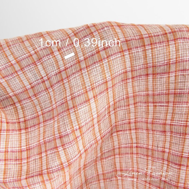 Checked linen fabric woven in white, orange, brown and red yarns