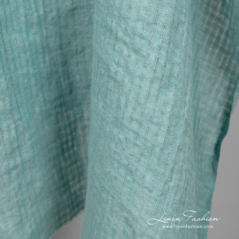 Blue green linen fabric in transparent checks, perfect for home textile and clothes