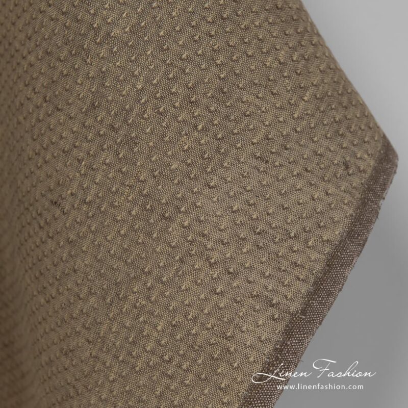 100% linen fabric in brown colour with spots.