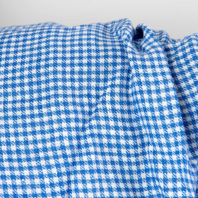 Washed linen fabric white blue twill small checks close up detail